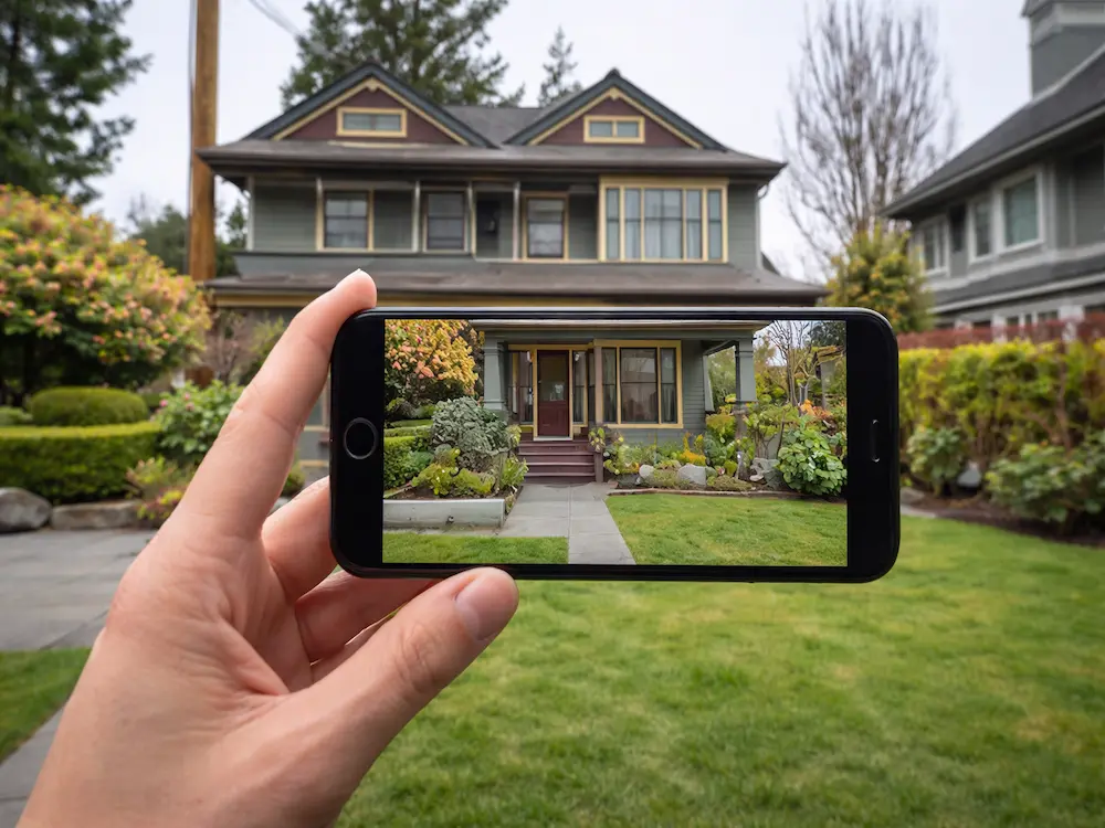 Homeowner documenting hail damage on roof with smartphone in Colorado Springs within 24 hours of storm