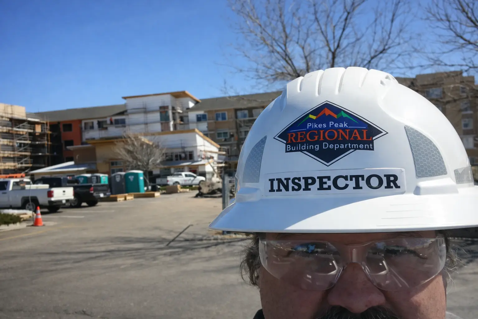 Building inspector documenting code compliance requirements at construction site for Pikes Peak Regional Building Department