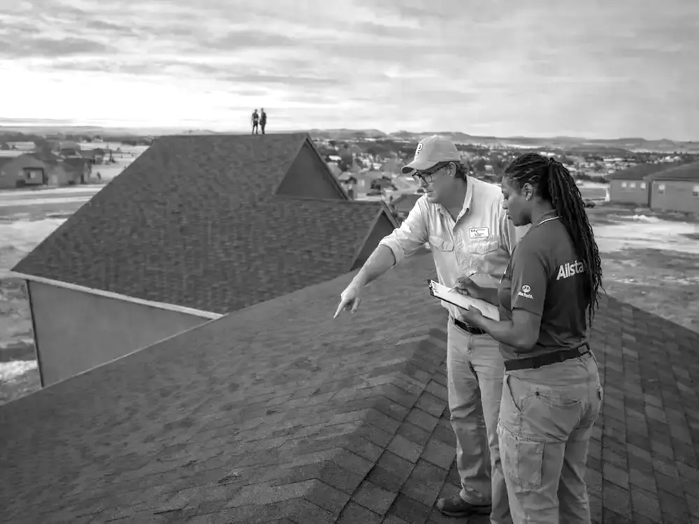 Roof consultant documenting storm damage during insurance adjuster meeting in Colorado Springs